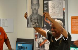 Ernest "Rip" Patton, Jr. holding a picture of himself during a visit to the Freedom Rides Museum in Montgomery, Alabama.