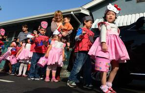 Schoolchildren dressed in Halloween costumes, Spiderman for boys and Hello Kitty for girls.