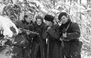 Russian partisans, one of them photographer Faye Schulman, gathering together in the forest, Naliboki Forest, Belarus, December 1944. The Molotava Brigade was a partisan group made up mostly of escaped Soviet Army POWs. The woman pictured is Faye Schulman, a Jewish woman who fled into the Naliboki forest with her camera equipment and joined the Molotova Brigade. For two years in the forest she photographed the partisan's activities, worked as medical aid and participated in the partisans raid's.