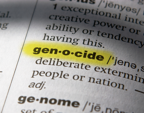 The term "genocide" is highlighted in a dictionary.