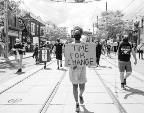 Black and white image of time for change protestor.
