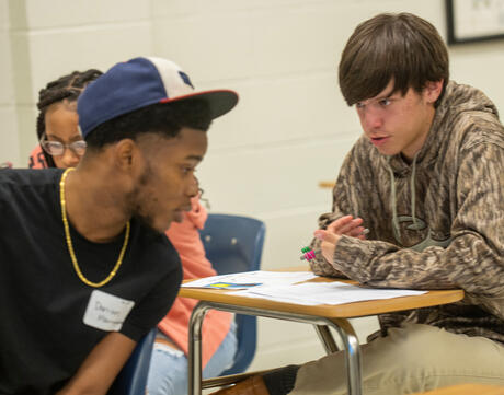 Two students discuss their work.