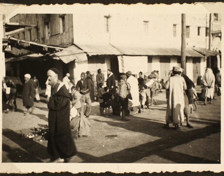 A group of people walk down a street in Casablanca.