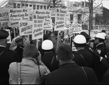  African American demonstrators outside The White House, with signs "We Demand The Right To Vote, Everywhere" and signs protesting police brutality against Civil Rights demonstrators in Selma, Alabama