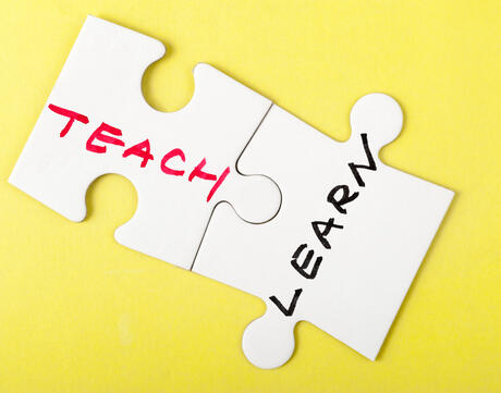 "TEACH" and "LEARN" puzzle pieces
