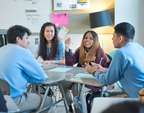 A group of students seated in a circle engaging in a discussion