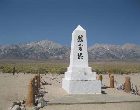 An obelisk memorial with Japanese Kanji characters that read “Soul Consoling Tower.”
