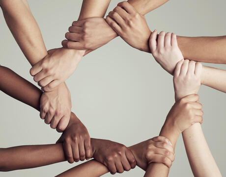 United through their diversity - hands of various colors forming a circle